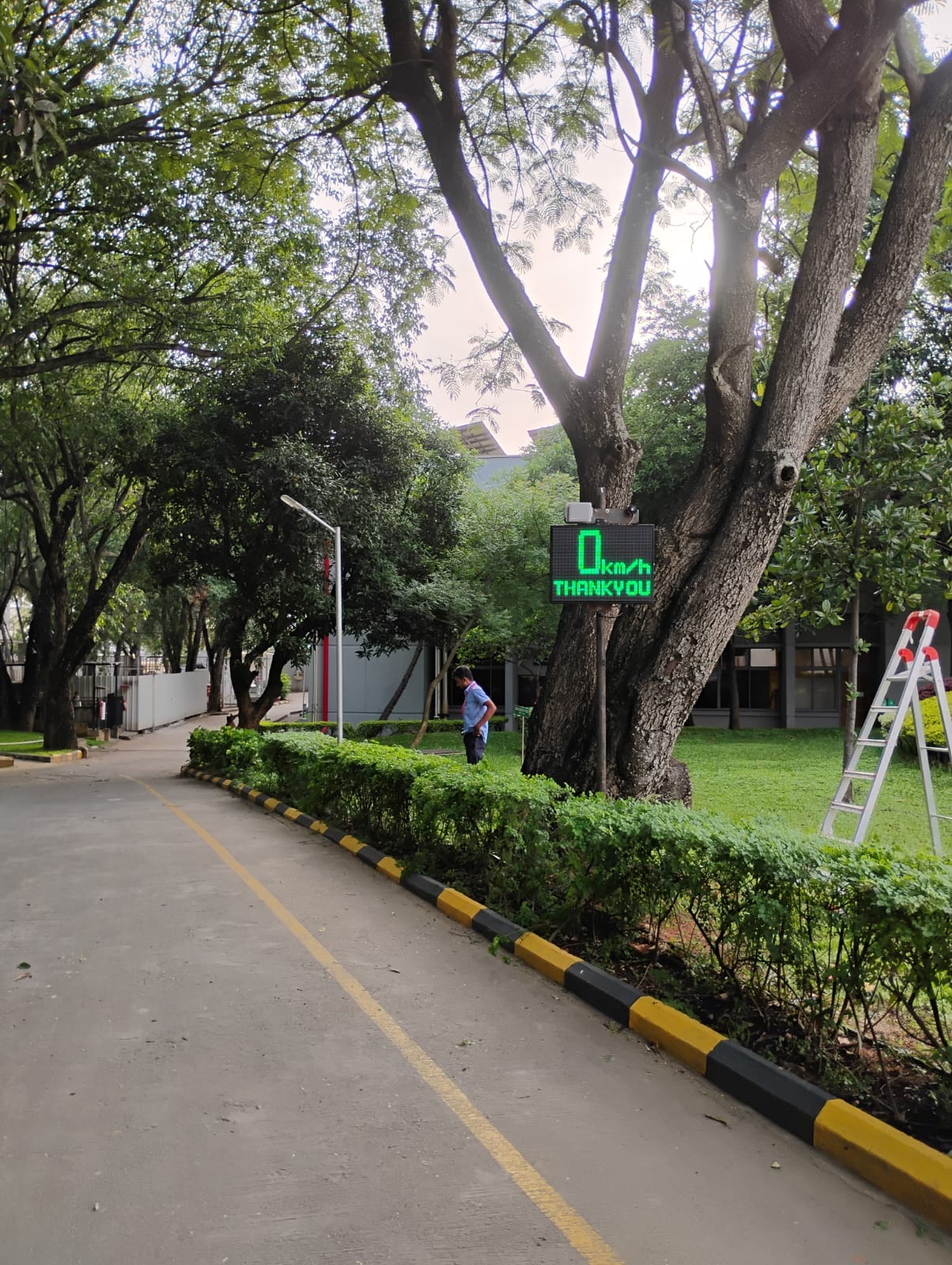 Radar speed display on a factory campus internal road shared by vehicles and pedestrians