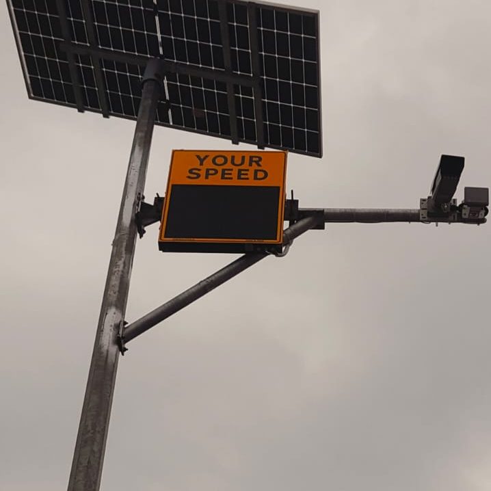 Solar panel, radar speed display and ANPR camera mounted together on a single highway pole
